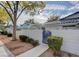 View of home featuring a small gated yard with an attractive blue gate and mature landscaping at 2132 Chertsey Dr # B, Las Vegas, NV 89108