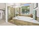 Luxurious bathroom featuring a soaking tub, a walk-in shower, and stylish tile work at 214 Piazzetta Pl, Henderson, NV 89011