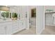 Elegant bathroom with dual sinks, white cabinetry, and a separate toilet area at 214 Piazzetta Pl, Henderson, NV 89011