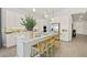 Modern kitchen featuring white cabinetry, a center island with seating, stainless steel appliances, and stylish pendant lighting at 214 Piazzetta Pl, Henderson, NV 89011