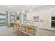 Bright kitchen features a central island with seating and modern lighting and cabinetry at 214 Piazzetta Pl, Henderson, NV 89011