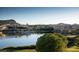 Scenic view of lakefront property with a golf course and buildings under a clear sky at 214 Piazzetta Pl, Henderson, NV 89011