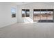 Bright living room featuring tile floors and sliding glass doors to the outdoor area at 218 Piazzetta Pl, Henderson, NV 89011