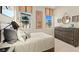 Cozy bedroom featuring golf art, a comfortable bed, and dresser at 227 Paraggi Bay Dr, Henderson, NV 89011