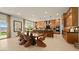 Bright, open-concept dining room featuring a modern table, island with bar seating, and ample cabinet space at 227 Paraggi Bay Dr, Henderson, NV 89011