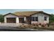 Charming single-story home featuring stone accents, desert landscaping, and a two-car garage at 227 Paraggi Bay Dr, Henderson, NV 89011