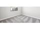 A carpeted bedroom with baseboards and a window providing natural light at 241 Paraggi Bay Dr, Henderson, NV 89011