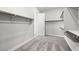 Walk-in closet featuring carpeted flooring, shelves, and hanging rods at 241 Paraggi Bay Dr, Henderson, NV 89011