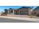 Beautiful single-story home with three-car garage, stone accents, and well-manicured landscaping at 241 Paraggi Bay Dr, Henderson, NV 89011