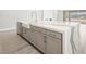 Bright kitchen features center island with marble countertop, white cabinets and stainless dishwasher at 241 Paraggi Bay Dr, Henderson, NV 89011