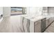 Open kitchen featuring a center island with marble countertop, stainless steel appliances and backyard views at 241 Paraggi Bay Dr, Henderson, NV 89011