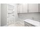 The laundry room features a utility sink, storage, and convenient access to a walk-in closet at 241 Paraggi Bay Dr, Henderson, NV 89011