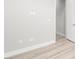 This room has neutral-colored walls, baseboards, and laminate wood flooring at 241 Paraggi Bay Dr, Henderson, NV 89011