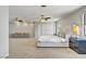 Spacious bedroom with carpet, ceiling fans, an ensuite sitting area, and a large bed with throw pillows at 2935 Hardin Dr, Henderson, NV 89074