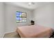 Bright bedroom featuring a ceiling fan, window view, and neutral paint at 2935 Hardin Dr, Henderson, NV 89074
