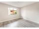 Bright bedroom features wood-look flooring, base molding, and a window at 3151 Soaring Gulls Dr # 2180, Las Vegas, NV 89128
