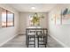 Modern dining area with a high-top table, four stools, natural light, and neutral decor, perfect for casual meals at 3151 Soaring Gulls Dr # 2180, Las Vegas, NV 89128