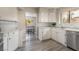 Bright kitchen features white cabinets, stainless steel appliances, and new flooring at 3151 Soaring Gulls Dr # 2180, Las Vegas, NV 89128