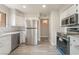 Bright kitchen with stainless steel appliances, ample white cabinetry, and a view to another room, creating a functional space at 3151 Soaring Gulls Dr # 2180, Las Vegas, NV 89128