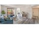 Bright living room with modern decor, gray wood floors, comfortable seating, and sliding doors to the outside at 3151 Soaring Gulls Dr # 2180, Las Vegas, NV 89128