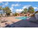 Community swimming pool featuring comfortable lounge chairs and a covered seating area for relaxation at 3151 Soaring Gulls Dr # 2180, Las Vegas, NV 89128