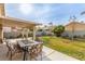 Backyard featuring a covered patio, green grass, desert landscaping, and neutral block wall at 3323 Bay Horse Ct, North Las Vegas, NV 89032