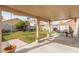 Outdoor backyard with patio, grassy area, and mature trees and landscape at 3323 Bay Horse Ct, North Las Vegas, NV 89032