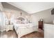 Cozy bedroom featuring a white-painted wood bed frame, wood floors, and light neutral walls at 3323 Bay Horse Ct, North Las Vegas, NV 89032