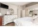 This bedroom features wood flooring, a dresser with a mirror, and neutral paint at 3323 Bay Horse Ct, North Las Vegas, NV 89032