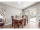 Dining room features a glass-top table, wood chairs, and access to the backyard at 3323 Bay Horse Ct, North Las Vegas, NV 89032