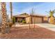 Charming home featuring a two-car garage, a well-manicured lawn, and desert landscaping at 3323 Bay Horse Ct, North Las Vegas, NV 89032
