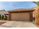 Charming home featuring a two-car garage, a well-manicured lawn, and desert landscaping at 3323 Bay Horse Ct, North Las Vegas, NV 89032