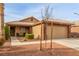 Charming home featuring a two-car garage, a well-manicured lawn, and desert landscaping at 3323 Bay Horse Ct, North Las Vegas, NV 89032