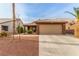 Charming single-story home with desert landscaping, a two-car garage and a tiled roof at 3323 Bay Horse Ct, North Las Vegas, NV 89032
