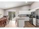 Bright kitchen with white cabinets, granite countertops, stainless steel appliances, and backyard access at 3323 Bay Horse Ct, North Las Vegas, NV 89032