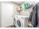 This laundry room includes front load washer and dryer, a utility sink, and storage shelf at 3323 Bay Horse Ct, North Las Vegas, NV 89032