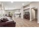 Bright, open-concept living room with wood-look floors, an archway, and sliding door to the backyard at 3323 Bay Horse Ct, North Las Vegas, NV 89032