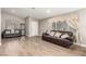 Inviting living room featuring wood-look tile flooring and comfortable leather sofas at 3323 Bay Horse Ct, North Las Vegas, NV 89032