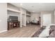 Open living room with wood-look tile flooring, comfortable leather sofas, and TV at 3323 Bay Horse Ct, North Las Vegas, NV 89032