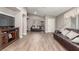 Spacious living room with wood-look tile flooring and comfortable leather sofas and TV at 3323 Bay Horse Ct, North Las Vegas, NV 89032