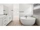 Bathroom featuring freestanding tub, tile surround, and vanity at 346 Tigullio Ave, Henderson, NV 89011