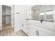 Bathroom with dual sinks, vanity with marble countertop, and walk-in closet at 346 Tigullio Ave, Henderson, NV 89011