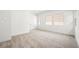 Spacious bedroom with three well-lit windows and plush carpeting at 346 Tigullio Ave, Henderson, NV 89011