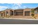Charming single-story home with a three-car garage and desert landscaping at 346 Tigullio Ave, Henderson, NV 89011