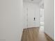 Bright hallway featuring wood-look floors and a white front door at 346 Tigullio Ave, Henderson, NV 89011