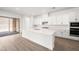 Modern kitchen with white cabinets, quartz countertops, island, and stainless steel appliances at 346 Tigullio Ave, Henderson, NV 89011