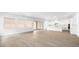Open living space with neutral walls, hardwood floors, fireplace, and kitchen in background at 346 Tigullio Ave, Henderson, NV 89011