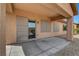 Relax on the covered back patio with desert landscaping and sliding door access to the home at 3544 Tack St, Las Vegas, NV 89122