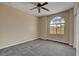 Bedroom featuring carpet, neutral walls and an arched window at 3544 Tack St, Las Vegas, NV 89122