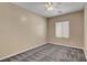 Bedroom with carpet flooring, tan walls, and a ceiling fan at 3544 Tack St, Las Vegas, NV 89122